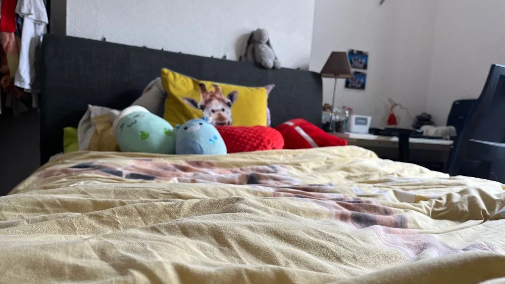Bed met geel dekbed, vooraanzicht